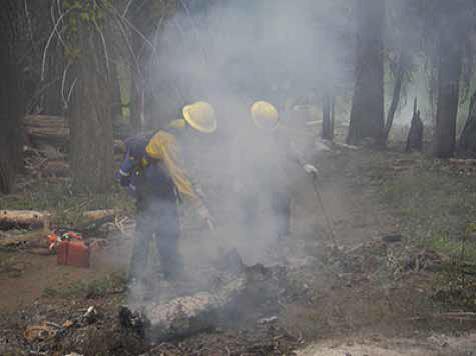 Smoke billowing in the faces of firefighters