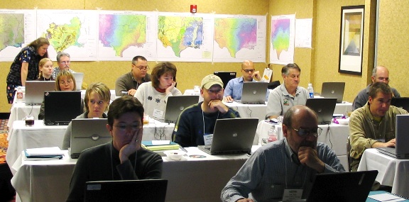 People in a classroom, looking at laptops